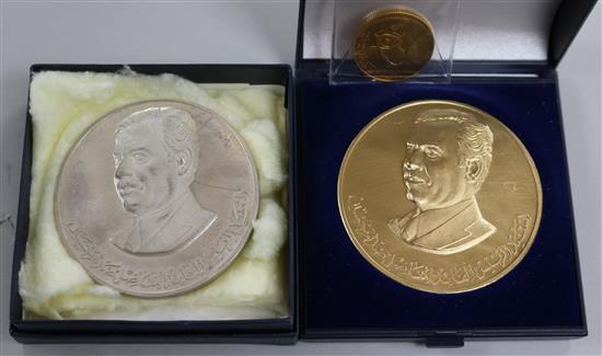 A 1980 Iraq Proof Gold 50 Dinars, commemorating the 15th Century of Hegira (tests as 22ct) and two Saddam Hussein medallions